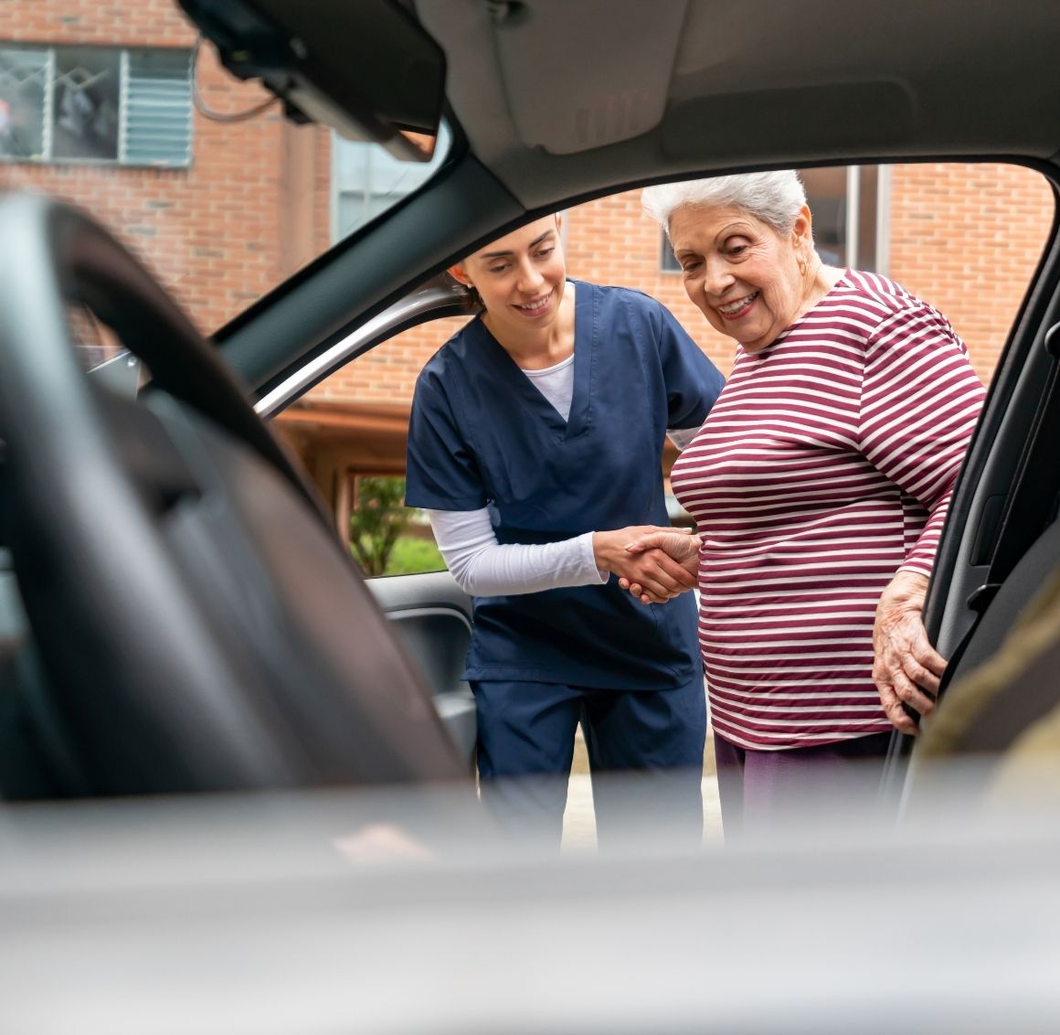 elderly receives assistance to ride car